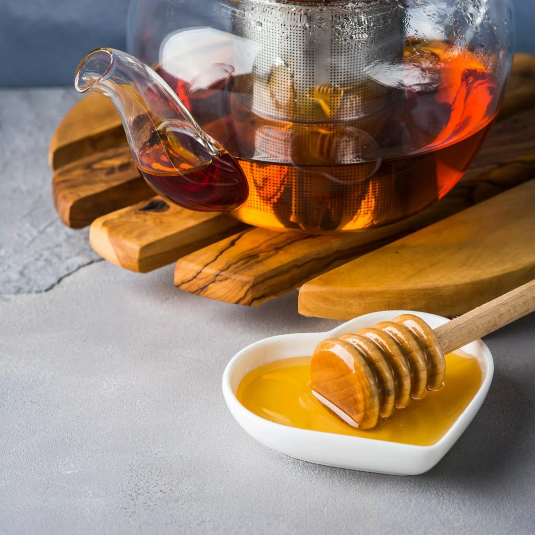 Teapot of red tea and honey