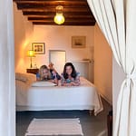 Two women lying on a bed laughing