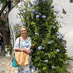 Lady in a dress in front of flowers