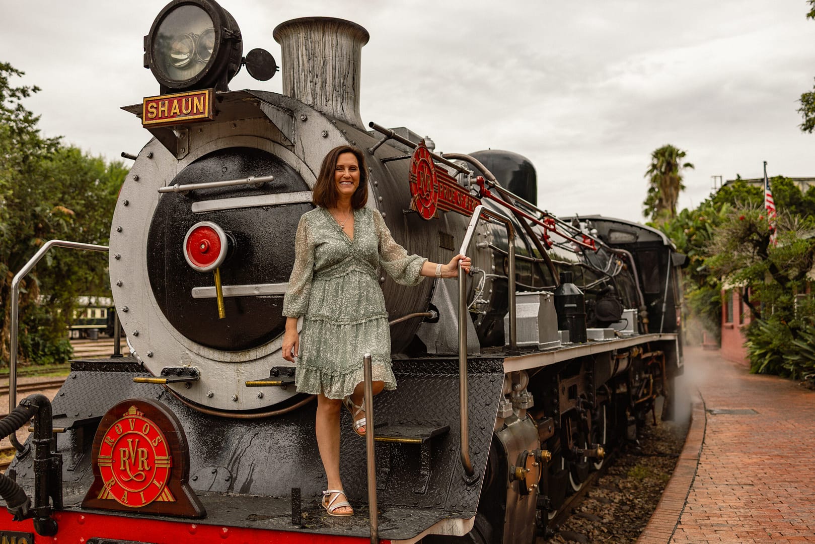 Petra standing on the steam locomotive of Rovos Rails