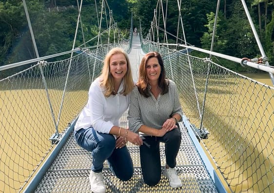 two women on bridge over river. Iller Brücke. How to start a travel blog