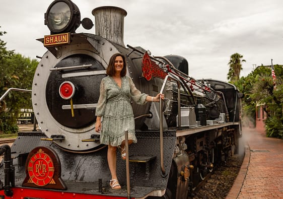 Petra standing on the steam locomotive of Rovos Rails