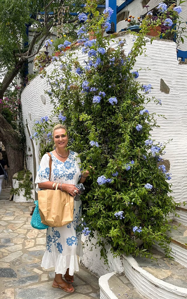 Lady in a dress in front of flowers