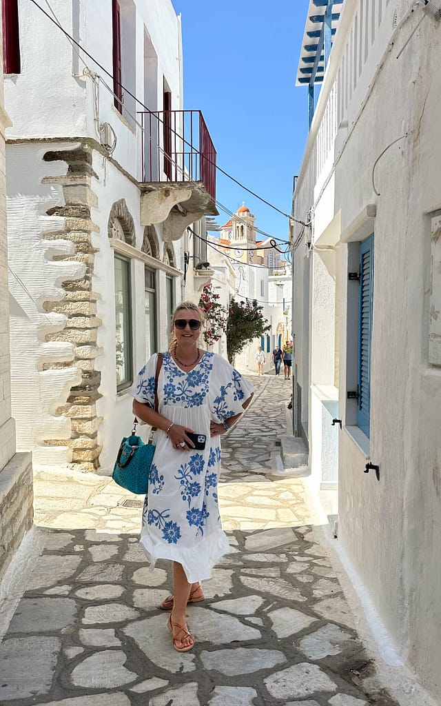 Lady in Greece alley, Pyrgos, Greece, whitewashed houses
