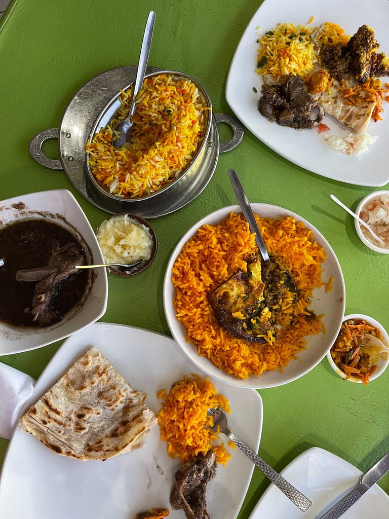 Travel buddies in Cape Town enjoying a traditional Cape Malay lunch at Biesmeillah restaurant