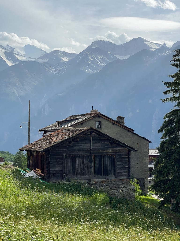 A typical historial wooden shed in Switzerland with views of the nearby town Gasenried
