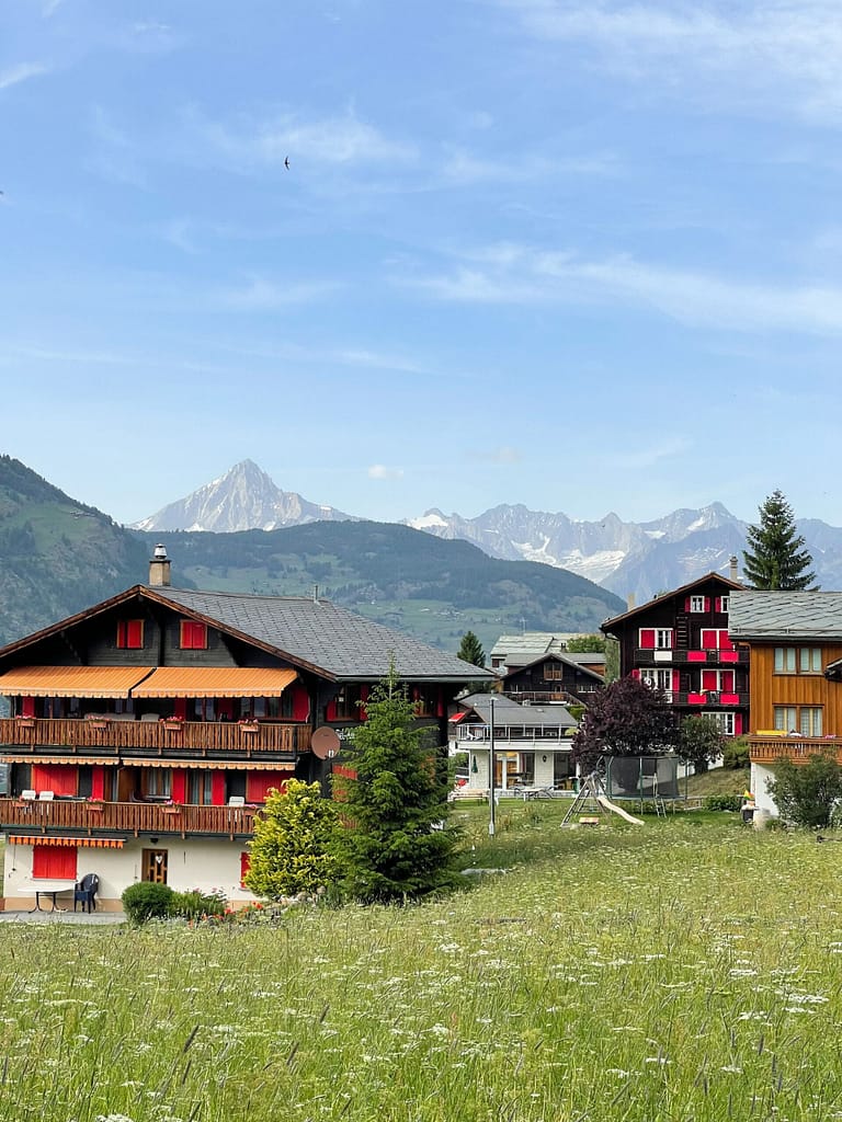 View of the fields, mountains and German-style houses in Switzerland