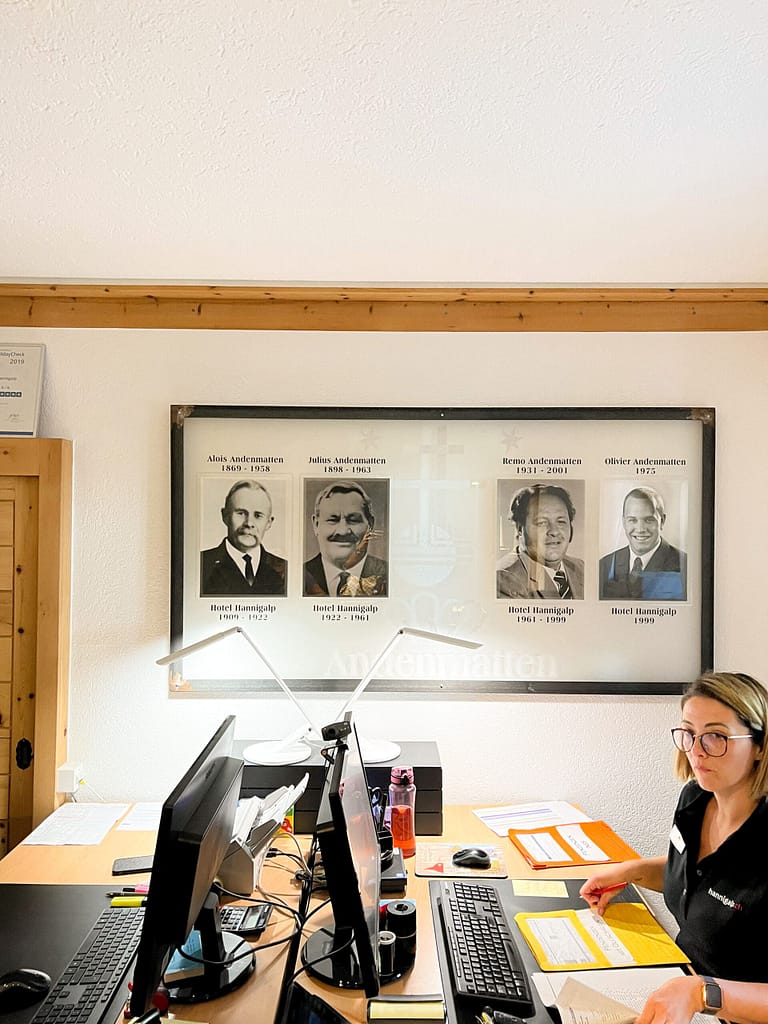 The receptionist sitting behind her desk at a traditional Switzerland Guest house