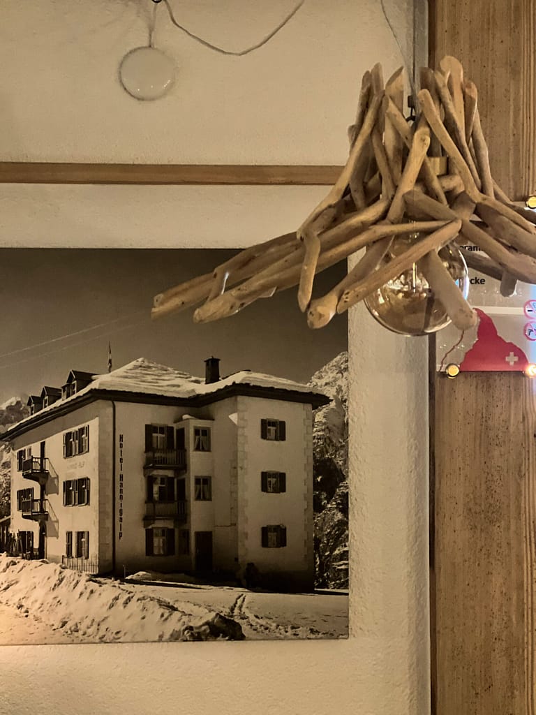 Historical photos against a wall in an old German-style hotel in Grächen