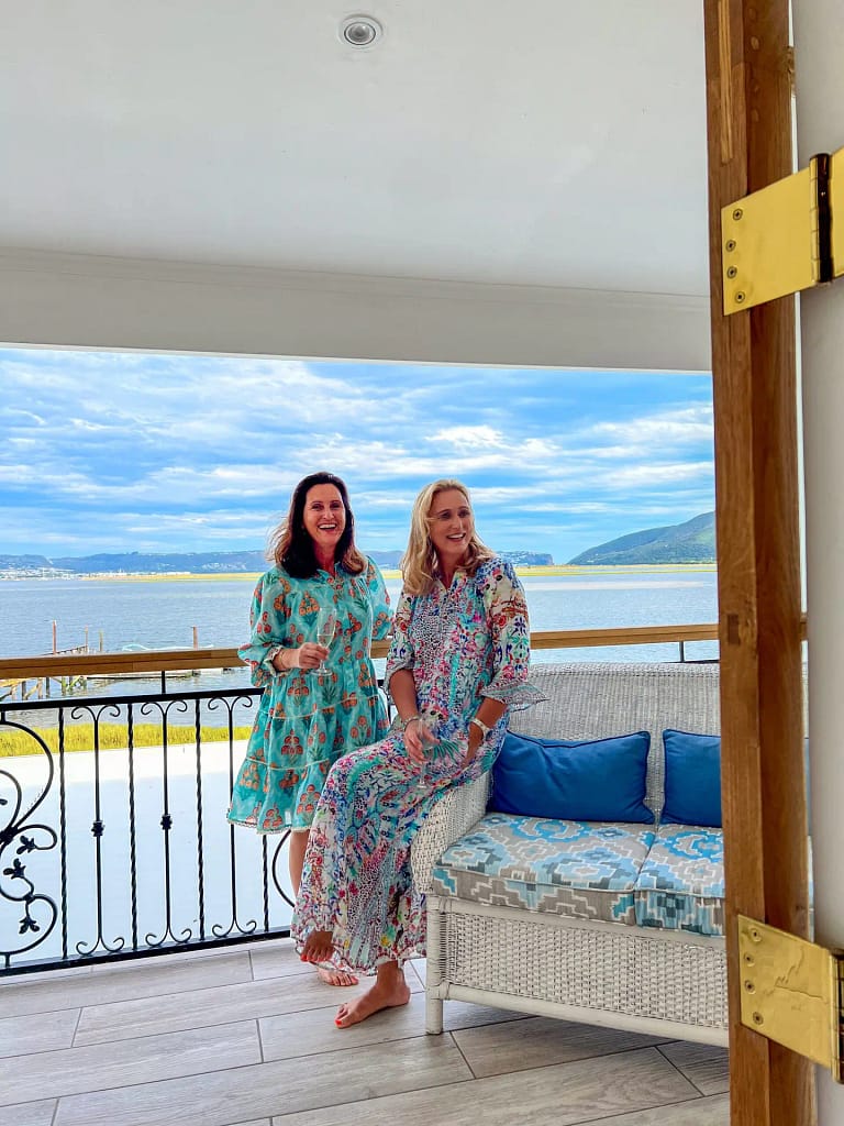 Our large balcony with Knysna Lagoon views with two ladies standing on the balcony