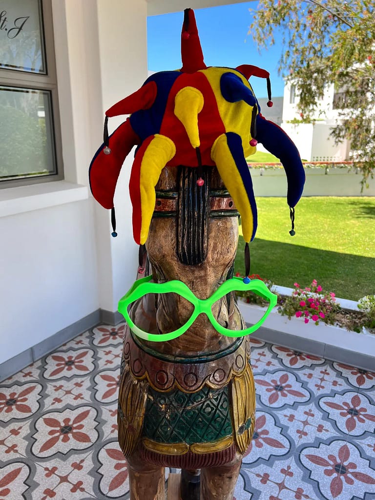 A wooden horse with a hat on