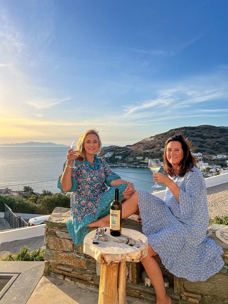 Travel bloggers Bernie and Petra enjoying sunset in greece on kini beach, Syros