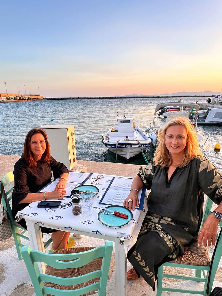 Two ladies eating at Tinos harbour