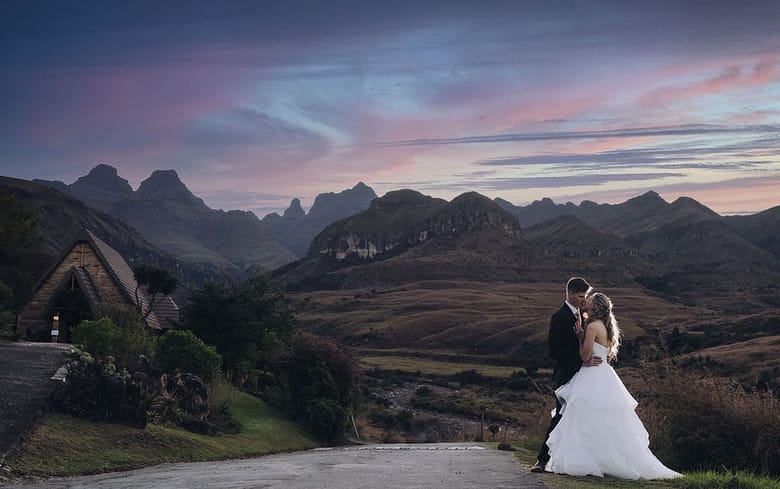 Romantic country side wedding photograph with mountains in the backdrop