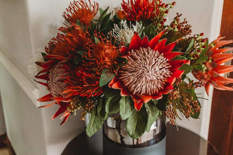 The welcoming ruby red protea flower arrangement in the reception area