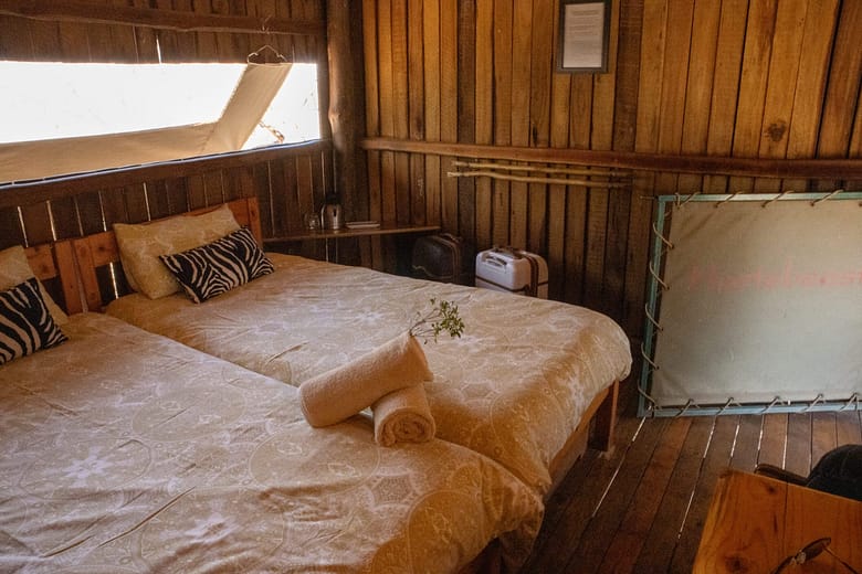 rustic single beds in a private game reserve in the bush