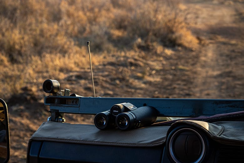 A pair of binoculars on the dash of a game vehicle