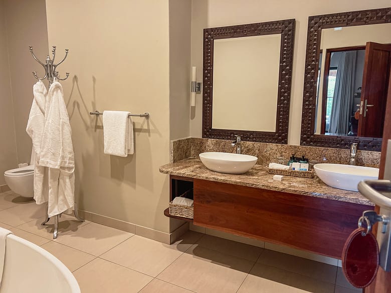 Our lovely appointed bathroom with double vanities and large walk-in rain shower